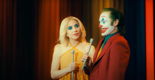 Lady Gaga and Joaquin Phoenix holding microphones in "Joker: Folie à Deux."