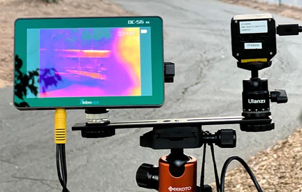 A small camera screen shows thermal readings of green, yellow and blue near a bike path. 