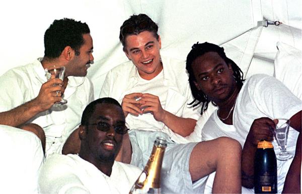 Leonardo DiCaprio (back center) and Sean ''Diddy'' Combs.(front center) relax with friends at Diddy's Labor Day White Party at his house in East Hampton, New York on August 29, 1998.