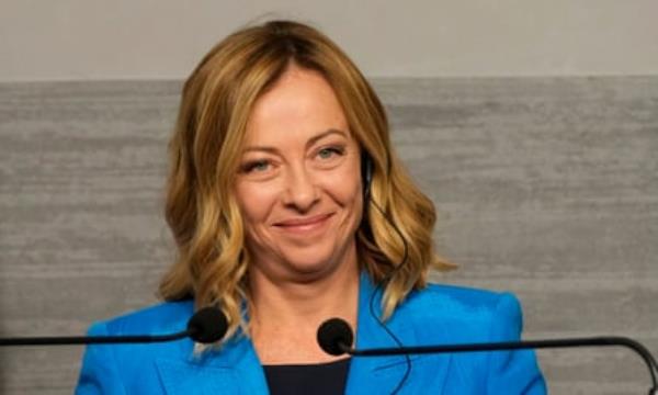 She smiles wearing blue jacket