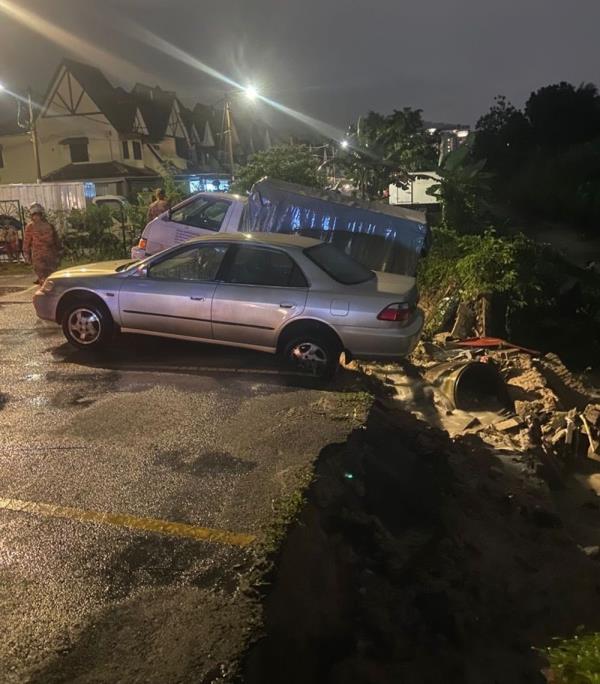 Two vehicles damaged as riverbank collapses in Ampang following heavy downpour, no casualties reported