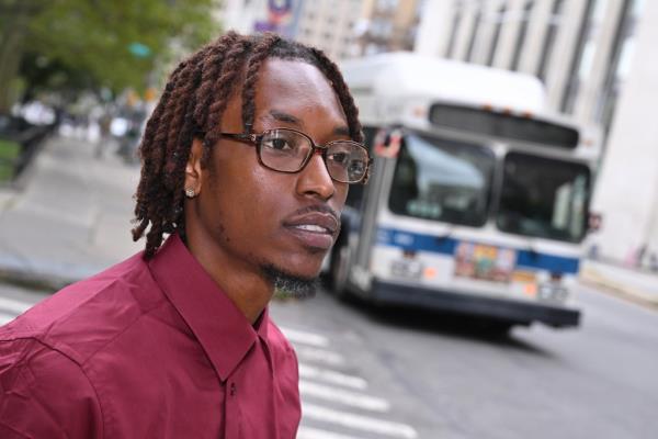 Malachi Houston standing outside a bus in NYC