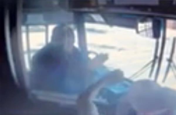 Grainy surveillance footage from inside the bus