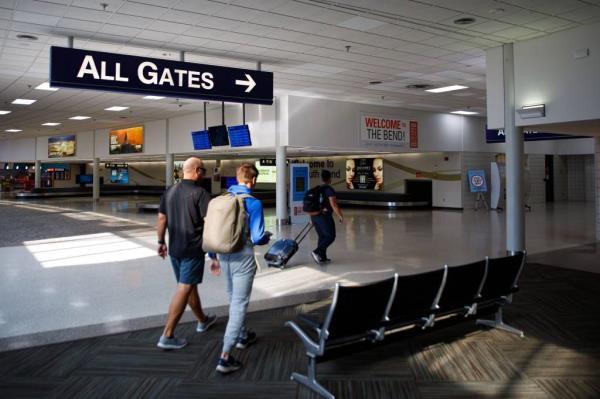 Passengers walking towards their gates at South Bend International Airport.