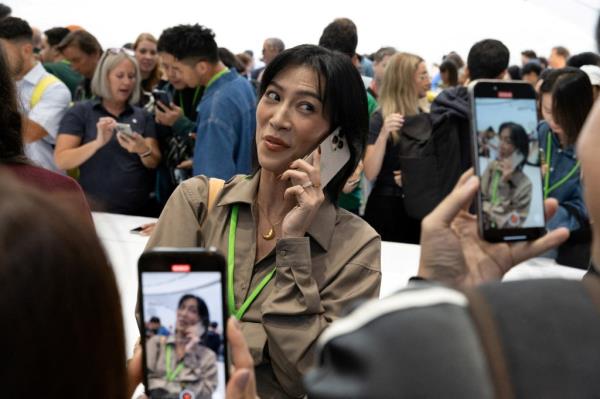 Attendee recording video on their new iPhone 16 Pro at Apple's event in Steve Jobs Theater, Cupertino, California.