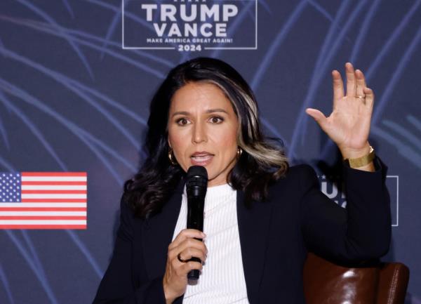 Former Democratic Rep. Tulsi Gabbard speaking into a microphone at the 'Reclaim America Tour' campaign event in Las Vegas, September 21, 2024