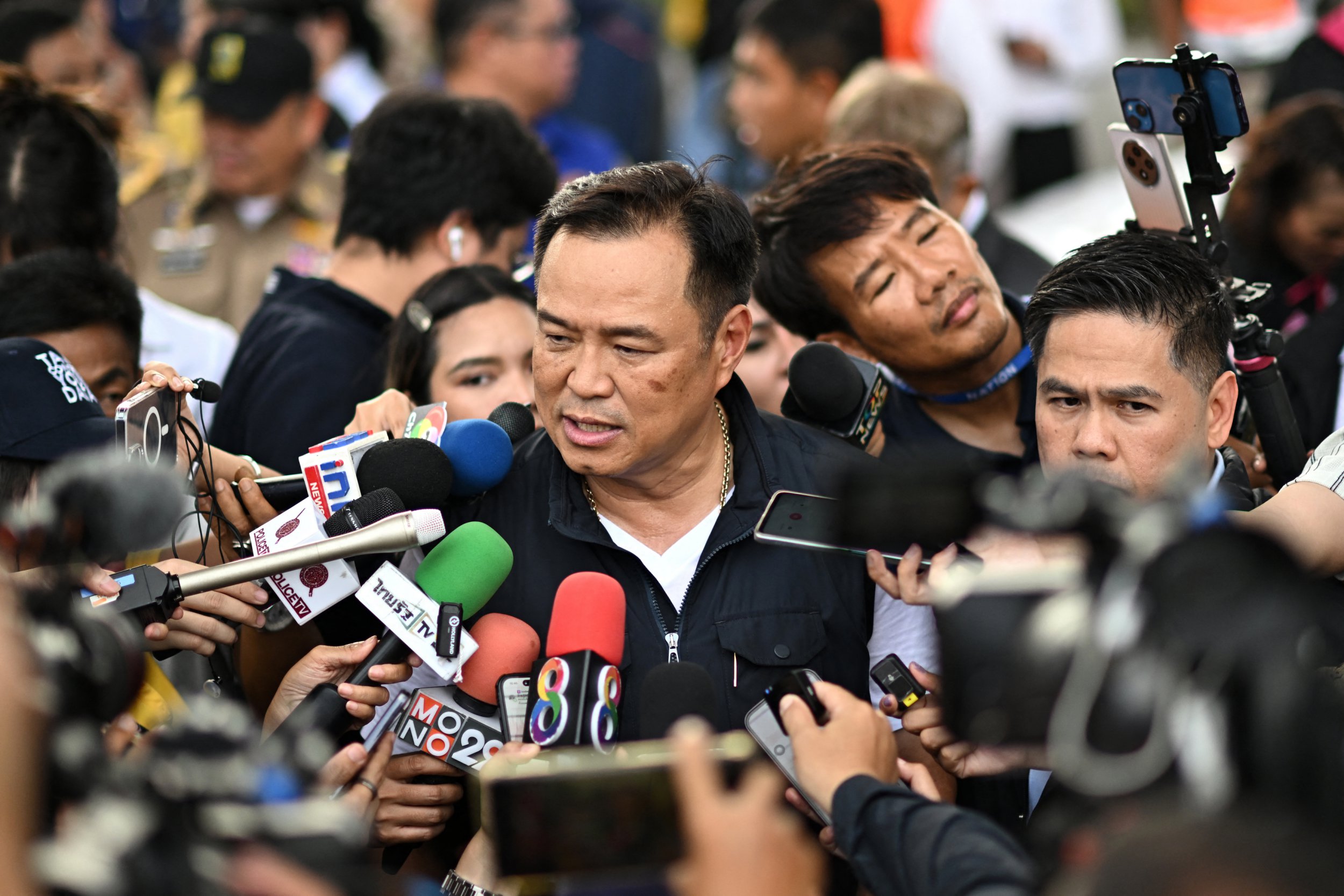 Thailand's Deputy Prime Minister and Interior Minister Anutin Charnvirakul (C) addresses the media at the site of a burnt-out bus that was carrying students and teachers on the outskirts of Bangkok, on October 1, 2024. A devastating fire tore through a Thai bus carrying 44 students and teachers on a school trip on October 1, officials said, with up to 25 feared dead. (Photo by Manan VATSYAYANA / AFP) (Photo by MANAN VATSYAYANA/AFP via Getty Images)