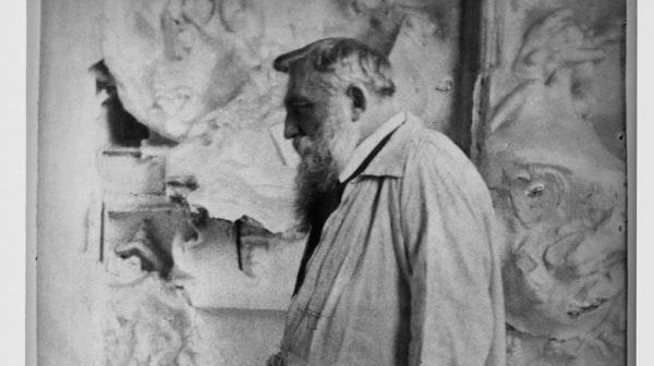 Sculptor Auguste Rodin with his work