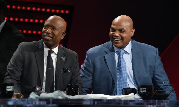 NBA analysts Kenny Smith (L) and Charles Barkley laugh during a live telecast of "NBA on TNT" at CES 2017 at the Sands Expo and Convention Center on January 5, 2017 in Las Vegas, Nevada.