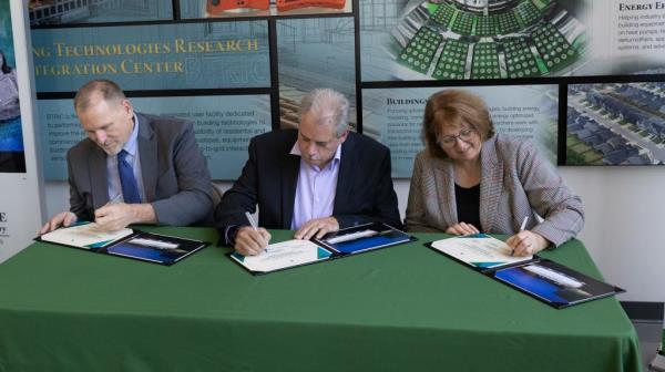 Wagner, Merwin and Jenks sign ceremonial licensing certificates.