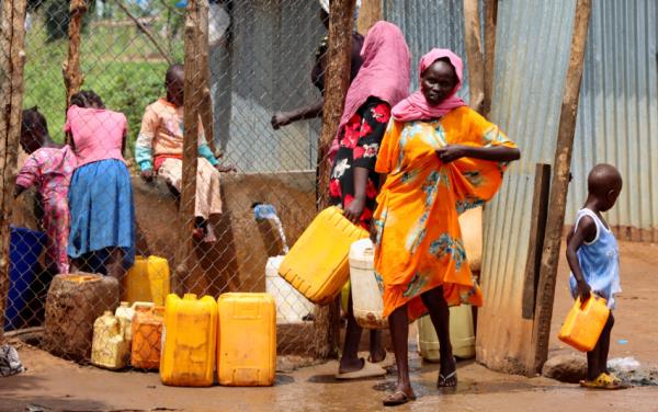 Sudanese refugees collect water from a tap at the Gorom Refugee camp near Juba