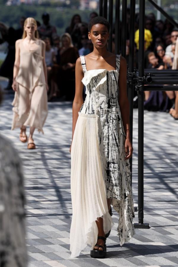 A model walking the runway in a white dress at the Jason Wu Collection fashion show during the September 2024 New York Fashion Week.