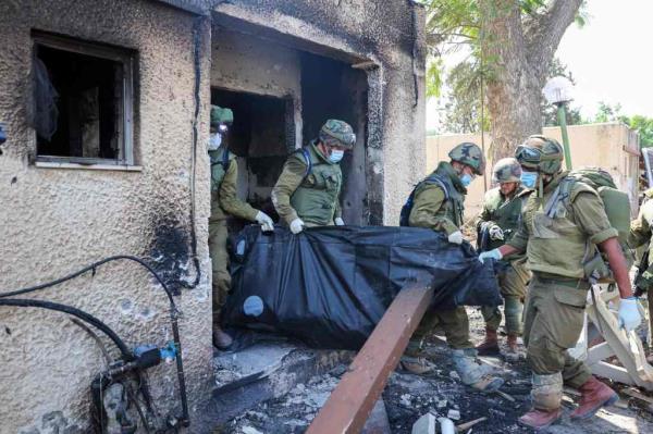 以色列士兵在2023年10月10日在以色列与加沙接壤的Kfar Aza移除被巴勒斯坦激进分子袭击致死的同胞的尸体