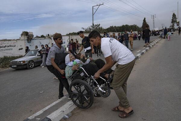 Palestinians flee to the southern Gaza Strip on Salah al-Din Street in Bureij. Picture: AP Photo/Fatima Shbair Palestinians flee to the southern Gaza Strip on Salah al-Din Street in Bureij. Picture: AP Photo/Fatima Shbair