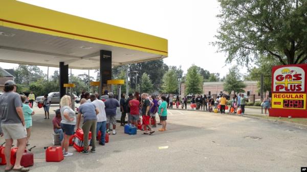 Residents wait in line with gas cans at a Gas Plus gas station in the aftermath of Hurricane Helene, Sept. 29, 2024, in North Augusta, South Carolina. 