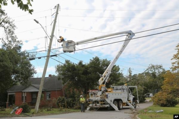 A Dominion Energy lineman works on a power line in the aftermath of Hurricane Helene, Sept. 29, 2024, in North Augusta, South Carolina.