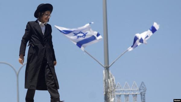 FILE- An ultra-Orthodox Jewish man reacts during a demonstration after the Supreme Court ruled the defense ministry could no longer grant blanket military conscription exemptions to Jewish seminary students, at Tel HaShomer recruitment base in Ramat Gan, Israel, Aug. 5, 2024. 