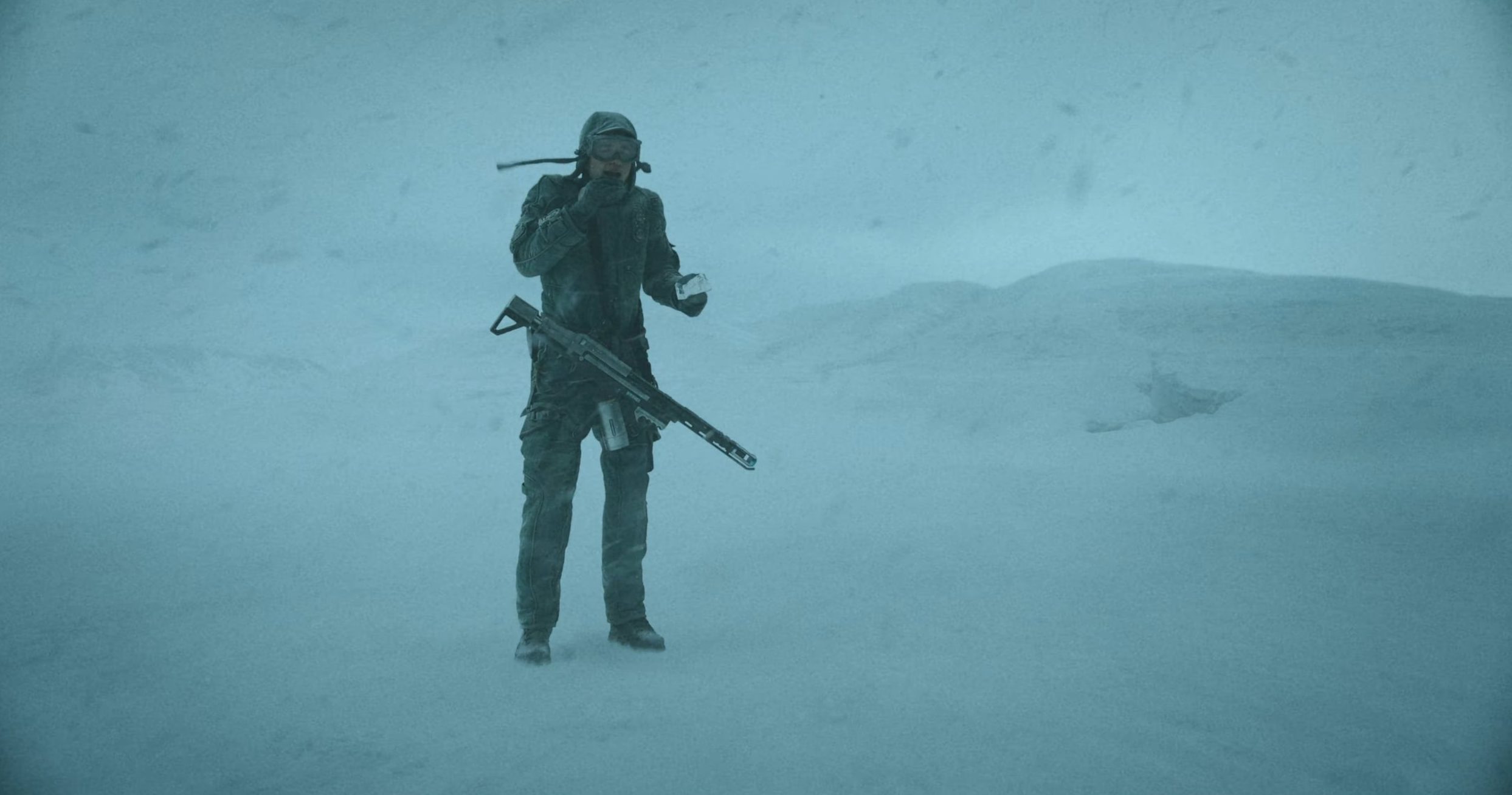 Robert Pattinson in Mickey 17 standing in a desolate wasteland