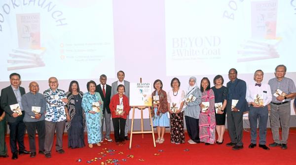 One for the album: Prof Wang (in red), Dr Aishah (fifth from left) and dean of UM’s Faculty of Medicine Prof Datuk Dr Yang Faridah Abdul Aziz (fourth from left) with some of the authors of the book at the launch. — AZHAR MAHFOF/The Star