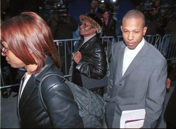 Shyne outside of court with lawyer, holding papers