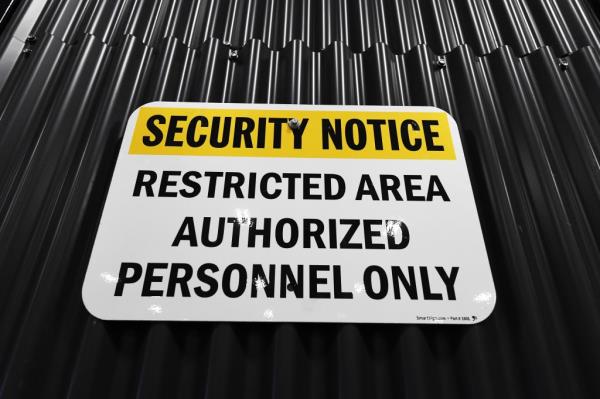 A fleet of black SUVs equipped with state-of-the-art security systems in a Secret Service's secured logistics hub, ready to transport world leaders to the UN and around town.