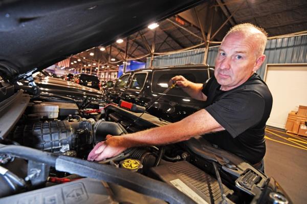 Protective Armoured Specialist Ronald Ball inspecting a Secret Service SUV in a secured logistics hub, preparing for the UN General Assembly
