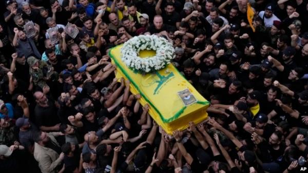 Hezbollah members carry the coffin of their comrade who was killed when a handheld device exploded, during a funeral procession in the southern suburbs of Beirut, Sept. 19, 2024.