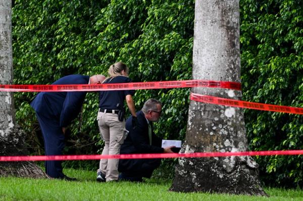 Law enforcement officials work at the crime scene outside the Trump International Golf Club in West Palm Beach, Florida, on September 16, 2024.