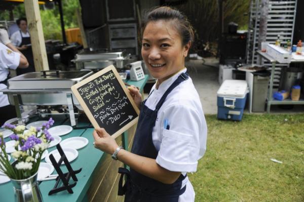 Top Chef contestant Shirley Chung holding a chalkboard in episode 1108, titled 'Pigging Out'