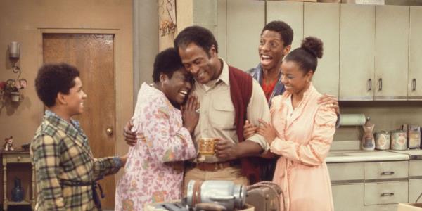 Good Times main family with characters embracing each other in the center