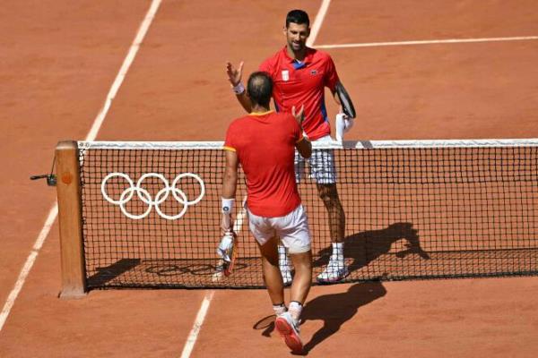 Serbia's Novak Djokovic shakes hands with Spain's Rafael Nadal after their men's singles second-round tennis match on Court Philippe-Chatrier at the Roland-Garros Stadium at the Paris 2024 Olympic Games, in Paris on July 29, 2024.