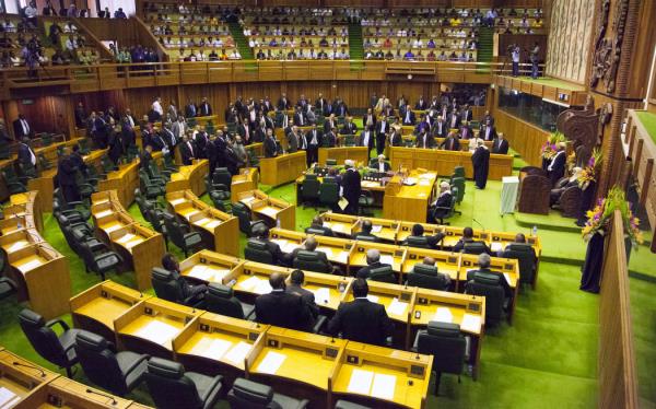 Members of parliament stand to the right of the speaker (R) to approve the vote of Peter O'Neill as prime minister in Port Moresby on August 3, 2012.