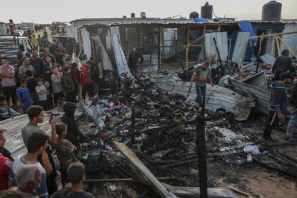 Palestinians look at the destruction after an Israeli strike where displaced people were staying in Rafah. Picture: AP Photo/Jehad Alshrafi Palestinians look at the destruction after an Israeli strike where displaced people were staying in Rafah. Picture: AP Photo/Jehad Alshrafi