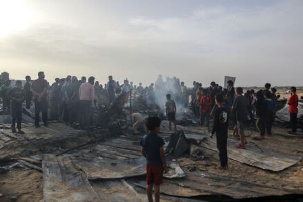 Palestinians look at the destruction after an Israeli strike where displaced people were staying in Rafah. Picture: AP Photo/Jehad Alshrafi Palestinians look at the destruction after an Israeli strike where displaced people were staying in Rafah. Picture: AP Photo/Jehad Alshrafi
