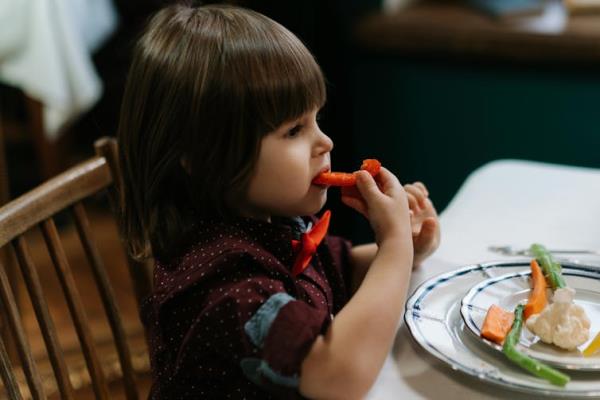 Toddler eats veggies
