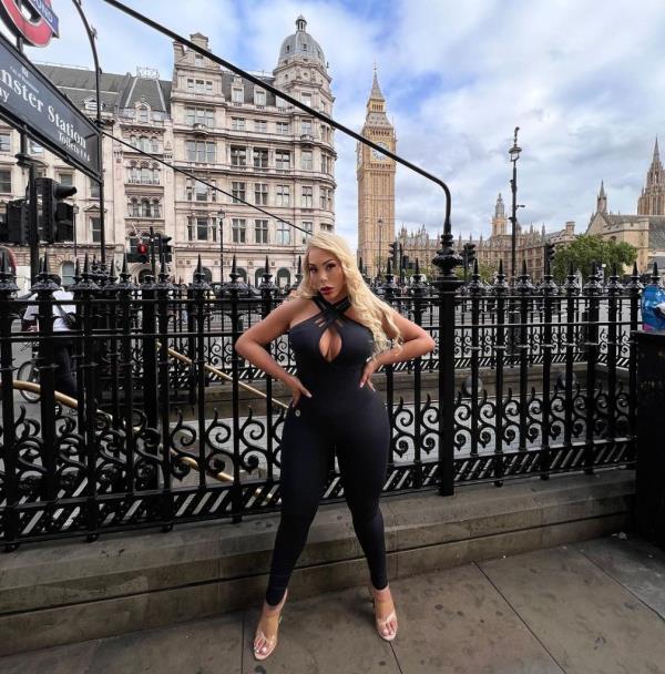 Image of Carey dressed in a black body suit in London.
The Elizabeth Tower can be seen in the background. 