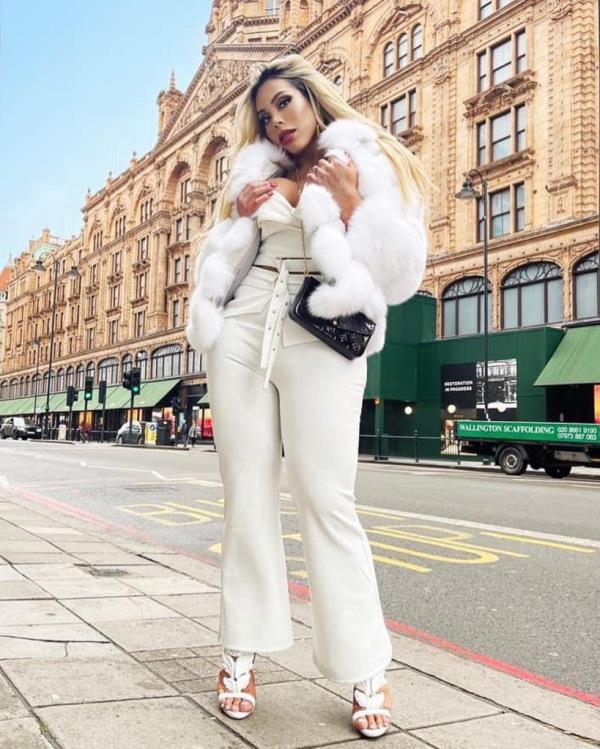 Image of Carey  posing in a white outfit.