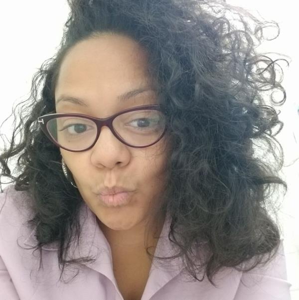 DOE staffer Shaquieta Boyd, seen here staring at the camera, pursing her lips, took her daughter on trips for homeless students because her boss Linda M. Wilson "not only gave me permission, she encouraged it."