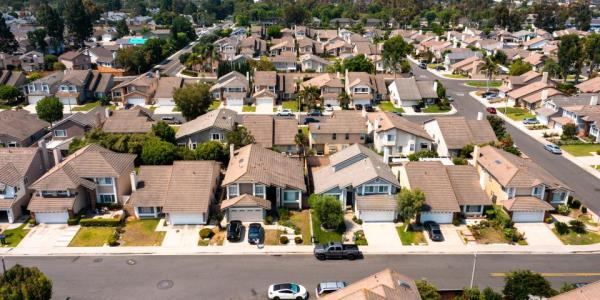 An above shot of houses, yards, and streets.