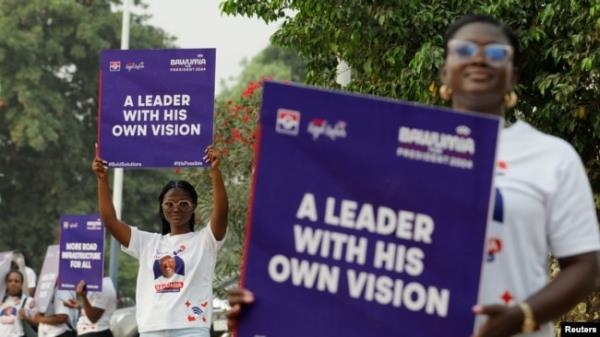 FILE - Supporters display placards during the campaign launch event of Ghana's Vice President and presidential candidate from the ruling New Patriotic Party (NPP), Dr. Mahamudu Bawumia ahead of the 2024 presidential election in Accra, Feb. 7, 2024.