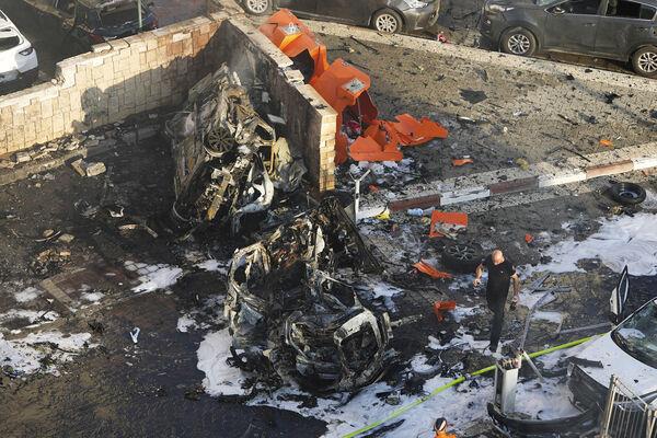 Israeli firefighters extinguish fire after a rocket fired from the Gaza Strip hit a parking lot in Ashkelon, southern Israel (Picture: AP /Tsafrir Abayov) Israeli firefighters extinguish fire after a rocket fired from the Gaza Strip hit a parking lot in Ashkelon, southern Israel (Picture: AP /Tsafrir Abayov)