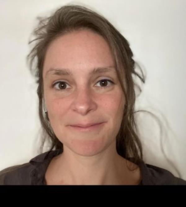 Portrait shot of a Dr Georgina Donati, a young woman with long brown hair.