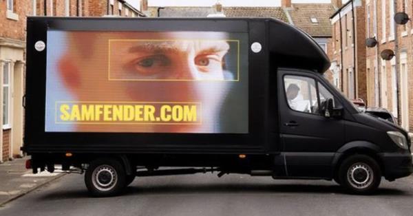 Billboard of Sam Fender on van 