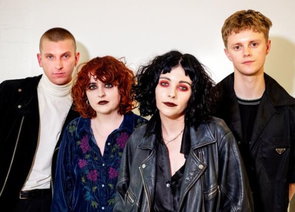 Charlie Wood, Ciara Doran, Heather Baron-Gracie and Hugo Silvani of Pale Waves pose backstage